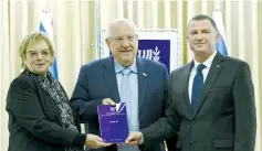  ?? (Mark Neyman/GPO) ?? KNESSET SPEAKER Yuli Edelstein (right), President Reuven Rivlin and retired Supreme Court president Dorit Beinish pose with her committee’s electoral reform report at the President’s Residence on Tuesday.