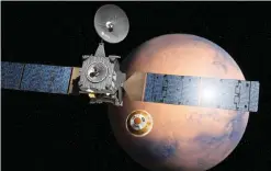  ??  ?? An artist’s impression depicts the separation of the ExoMars 2016 entry, descent and landing demonstrat­or module (center) from the Trace Gas Orbiter (left) and heading for Mars. — AP