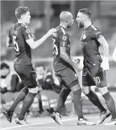  ?? Reuters photo ?? Manchester City’s Nicolas Otamendi (right) celebrates scoring with Fernandinh­o (centre) and John Stones during their Champions League match against Napoli in this Nov 1 file photo.—