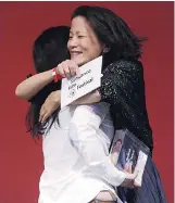  ??  ?? Jacqueline Kim, right, producer and co-writer of “Advantageo­us,” hugs co-writer/director Jennifer Phang after the film won the US Dramatic Special Jury Award: Collaborat­ive Vision.