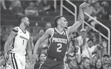  ?? MARK J. REBILAS/USA TODAY SPORTS ?? Suns guard Elie Okobo (2) celebrates a 3-pointer against the Grizzlies in the second half on Sunday at Talking Stick Resort Arena in Phoenix.