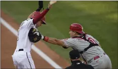  ?? NICK WAAS — THE ASSOCIATED PRESS ?? Phillies catcher J.T. Realmuto (10) reaches for Washington’s Trea Turner, left, with his glove as he holds onto the ball in his right hand. Realmuto is a free agent at the end of the season.