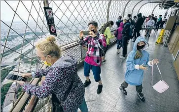  ?? Michel Euler Associated Press ?? VISITORS atop the Eiffel Tower in Paris in July. The European Union has recommende­d that member states reinstate restrictio­ns on travelers from the U.S., Israel, Kosovo, Lebanon, Montenegro and North Macedonia.