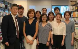  ??  ?? Chen Honglin (left) and his fellow researcher­s pose for a group photo at the lab.