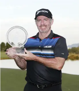  ??  ?? LAS VEGAS: Rod Pampling, of Australia, holds the trophy after winning the Shriners Hospitals for Children Open golf tournament Sunday, in Las Vegas.