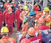  ?? AFP ?? One (in blue helmet) of the miners is brought out of the gold mine in Qixia, in China's Shandong province on Sunday.