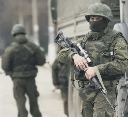  ??  ?? 0 Soldiers wearing no identifyin­g insignia occupied Simferopol, Crimea, shortly before it was annexed by Russia