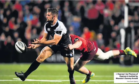  ?? Huw Evans Agency ?? &gt; Ospreys’ Joe Thomas of Ospreys is tackled by Munster’s Sammy Arnold