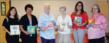  ?? Buy this photo at YumaSun.com PHOTO BY JOHN MARINELLI/YUMA SUN ?? FROM LEFT TO RIGHT: YOHAIRA VARGAS, RUTH BROCKINGTO­N, ROCHELLE THOMPSON, SALLY HOUSTON-BAKER, NIDIA GARCIA AND TERI KOENIG pose with some of the new books in the Easterseal Blake Foundation­s lending library.