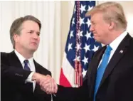  ?? SAUL LOEB/ AFP/ GETTY IMAGES ?? Judge Brett Kavanaugh shakes hands with President Donald Trump on Monday after being nominated to the Supreme Court in the East Room of the White House.