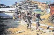  ?? REUTERS ?? Rohingya refugees carry wood branches at the Balukhali refugee camp near Cox's Bazar, Bangladesh, on Sunday.