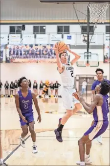  ?? Tim Godbee ?? Calhoun senior Gage Maffetone drives to the net during the Yellow Jackets’ game against Cartersvil­le at Calhoun High School on Friday, Dec. 20.