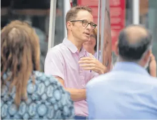  ?? RYAN TAPLIN • THE CHRONICLE HERALD ?? Dalhousie professor John Archibald speaks to a small crowd outside Cyclesmith on Agricola Street on Friday. Archibald recently completed a bike trip around Nova Scotia and raised around $25,000 to help people affected by dementia and also for dementia research and brain donation.