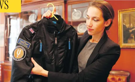  ?? FRANK AUGSTEIN/THE ASSOCIATED PRESS ?? A bomber jacket is one of the possession­s of Stephen Hawking displayed at Christie’s auction house in London. The online auction announced Monday will feature 22 items from Hawking, including his doctoral thesis on the origins of the universe.