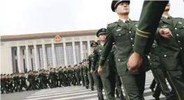  ??  ?? BEIJING: Chinese paramilita­ry policemen march outside the Great Hall of the People after attending a ceremony to commemorat­e the 90th anniversar­y of the founding of the People’s Liberation Army. — AP