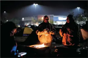  ?? MARCUS YAM/LOS ANGELES TIMES ?? Evacuees from the Camp Fire have congregate­d in tents and in their vehicles as they seek shelter in a Walmart parking lot in Chico on Tuesday.