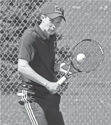  ?? DAVE KALLMANN / MILWAUKEE JOURNAL SENTINEL ?? Marquette’s John Massart returns a shot in the No. 1 doubles championsh­ip match on Saturday afternoon.