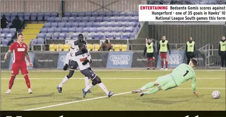  ??  ?? ENTERTAINI­NG Bedsente Gomis scores against Hungerford - one of 35 goals in Hawks’ 10 National League South games this term