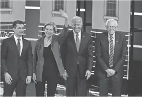  ?? SAUL LOEB/AFP VIA GETTY IMAGES ?? Pete Buttigieg, left, Sen. Elizabeth Warren, former Vice President Joe Biden, and Sen. Bernie Sanders onstage.