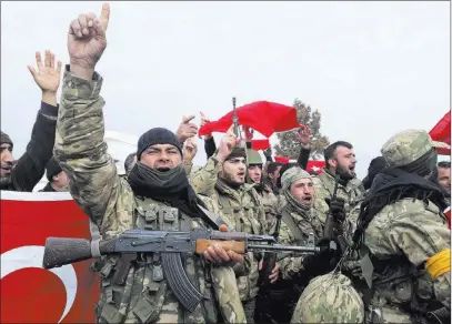  ?? Furkan Arslanoglu ?? The Associated Press Turkey-backed Free Syrian Army fighters shout Sunday in Kirikhan, Turkey, before heading toward the Syrian border.