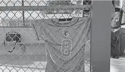  ?? THEO MACKIE/THE REPUBLIC ?? Faith Moore's jersey hangs in the dugout during Mingus Union’s 4A softball playoff game on Tuesday.