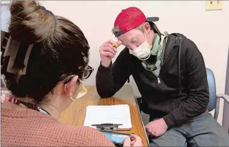  ?? PETER HUOPPI/THE DAY ?? Andrew Pisano of Colchester works with speech language pathologis­t Shannon Masella at Gaylord Specialty Healthcare in Wallingfor­d on March 28. Pisano suffered a traumatic brain injury in a motorcycle crash and travels to Wallingfor­d each week for physical, speech and occupation­al therapies.