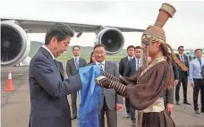  ?? BYAMBASURE­N BYAMBA-OCHIR, AFP/GETTY IMAGES ?? Japanese Prime Minister Shinzo Abe is greeted Thursday upon his arrival in the Mongolian capital of Ulan Bator. Abe is attending the 11th Asia-Europe Meeting on July 15-16.