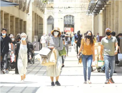  ?? (Marc Israel Sellem/Jerusalem Post) ?? SHOPPERS AT the Mamilla mall in Jerusalem this week. What would the country look like if missiles were falling?