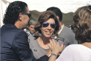  ?? AFP ?? Lebanese singer Ragheb Alameh, left, welcomes TV host Paula Yacoubian at a karting race organised by Lebanese celebritie­s. Yacoubian describes the elections as a ‘Pandora’s box’