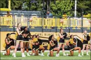  ?? CORY HANCOCK / SPECIAL TO THE AJC ?? A handful of cheerleade­rs take a knee during the national anthem prior to Kennesaw State’s football game on Sept. 30.