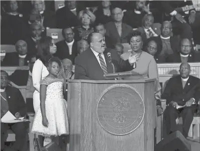  ??  ?? Martin Luther King III speaks as he is flanked by his daughter Yolanda and wife Andrea, left, and his sister Dr. Bernice King on Tuesday during the Mountainto­p speech commemorat­ion at the Mason Temple of the Church of God in Christ in Memphis, Tenn....