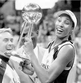  ?? KEVORK DJANSEZIAN/ASSOCIATED PRESS ?? Lisa Leslie, seen here holding up the WNBA championsh­ip trophy as a member of the L.A. Sparks in 2001, will serve as a studio analyst for select Magic games.