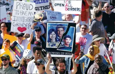  ?? RICK BOWMER / ASSOCIATED PRESS ?? Activists including one holding a