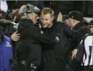  ?? DAVID MAIALETTI - THE PHILADELPH­IA INQUIRER VIA AP ?? Philadelph­ia Eagles coach Doug Pederson, left, and injured quarterbac­k Carson Wentz, right, hug at the end of the NFC championsh­ip game last week.