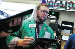  ?? RICHARD DREW / THE ASSOCIATED PRESS ?? A trader works the floor of the NYSE, where stocks failed to recover ground lost last week in a major sell-off.