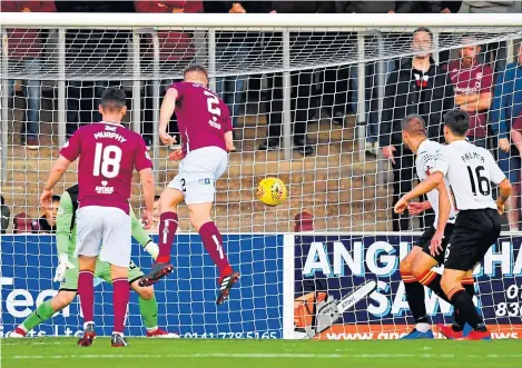  ?? Picture: SNS. ?? Jason Thomson heads Arbroath in front at Gayfield last night.