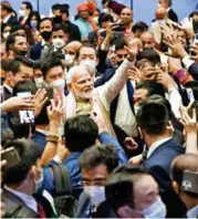 ?? ?? Prime Minister Narendra Modi greets members of the Indian diaspora during an event, in Tokyo, on Monday