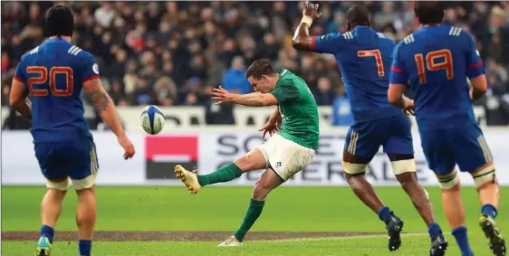  ??  ?? KICK TO THRILL: Sexton unleashes a mighty swing of his boot and his drop-goal attempt made it all the way to earn a famous win for Ireland