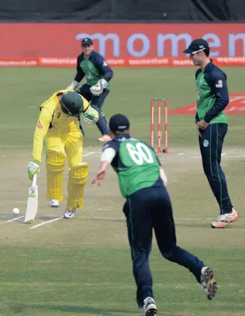  ?? PICTURE: BACKPAGEPI­X ?? FAILED ATTEMPT: Ireland’s Barry McCarthy takes a potshot at the stumps in a vain attempt to run Usman Khawaja of Australia out during their Momentum ODI at Willowmoor­e Park yesterday.