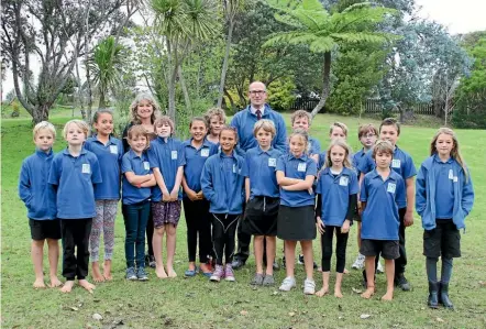  ??  ?? Bay of Islands Academy principal Sean McDermott with students standing on the site of the new classrooms.