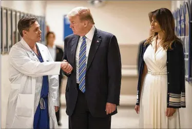  ?? ALLEN EYESTONE / THE PALM BEACH POST ?? President Donald Trump, accompanie­d by first lady Melania Trump, shakes the hand of Dr. Igor Nichiporen­ko at Broward Health North Hospital in Pompano Beach on Friday evening.