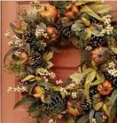  ?? PHoTo courTeSy BalSamHIll.com ?? COLORFUL GREETING: The Autumn Abundance Foliage Wreath from Balsam Hill offers a warm welcome.