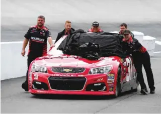  ?? — AFP ?? BRISTOL: Crew members push #31 Grainger Chevrolet, driven by Ryan Newman (not pictured), through the garage area during practice for the Monster Energy NASCAR Cup Series Food City 500 at Bristol Motor Speedway yesterday in Bristol, Tennessee.