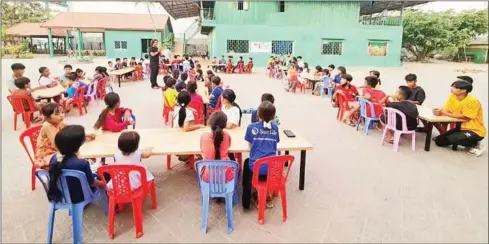  ?? BRANCH CENTRE ?? Branch Centre director Phorn Phalla talks to children at the centre in August.