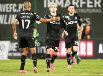  ?? — AFP photo ?? Sporting Lisbon’s midfielder Pedro Goncalves (centre) celebrates after scoring a penalty shot during the Portuguese League match between Rio Ave FC and Sporting Portugal at the Rio Ave FC - Dos Arcos stadium in Vila do Conde.