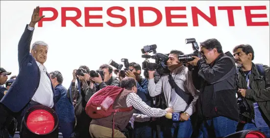  ?? PEDRO MERA / GETTY IMAGES ?? President elect, Andres Manuel Lopez Obrador acknowledg­es the crowd during a celebratio­n event at the end of the Mexico’s presidenti­al election Sunday in Mexico City. López Obrador secured an estimated 53 percent of the vote with a campaign focused on...