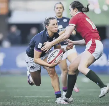  ?? ?? Lisa Neumann of Wales tries to tackle Scotland’s Emma Orr at Cardiff Arms Park