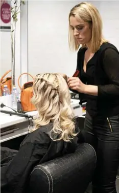  ?? PHOTO: CONTRIBUTE­D ?? GET GLAM: A Price Attack stylist works on a fabulous hairstyle.