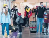  ?? DAVID ZALUBOWSKI/AP ?? Travelers check in at a ticket counter Dec. 31 at Denver Internatio­nal Airport.