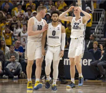  ?? DARREN HAUCK — THE ASSOCIATED PRESS ?? Stopping Markus Howard, center, isn’t Villanova’s only task against Marquette Saturday. The Wildcats also have to contend with Sam Hauser, left, and Joey Hauser, right, to stay undefeated in the Big East.